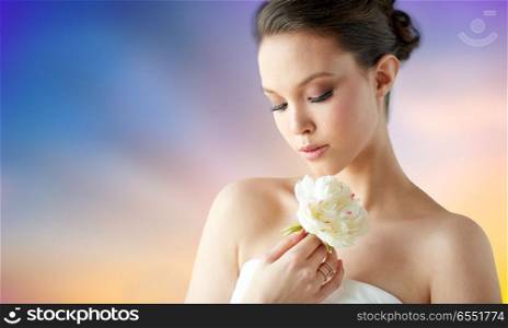 beauty, jewelry, people and luxury concept - beautiful asian woman or bride in white dress with peony flower and golden ring over pastel background. beautiful asian woman with flower and golden ring. beautiful asian woman with flower and golden ring