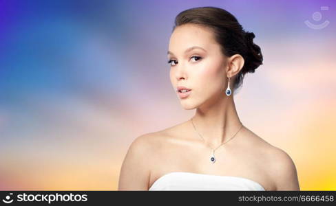 beauty, jewelry, people and luxury concept - beautiful asian woman or bride with earring and pendant over pastel background. beautiful asian woman with earring and pendant. beautiful asian woman with earring and pendant