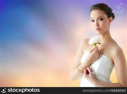 beauty, jewelry, people and luxury concept - beautiful asian woman or bride in white dress with peony flower, golden ring and bracelet over pastel background. beautiful asian woman with flower and jewelry. beautiful asian woman with flower and jewelry