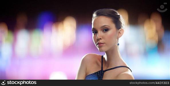 beauty, jewelry, people and luxury concept - beautiful young asian woman with earring over night lights background
