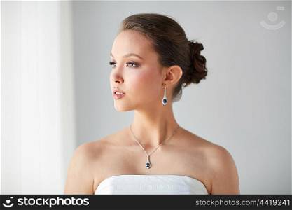 beauty, jewelry, wedding accessories, people and luxury concept - beautiful asian woman or bride with earring and pendant