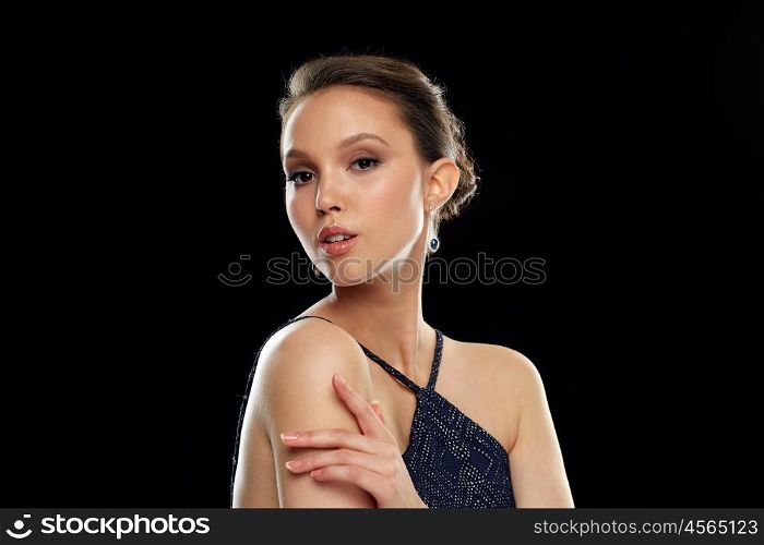 beauty, jewelry, wedding accessories, people and luxury concept - beautiful asian woman with diamond earring over black background