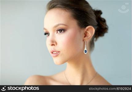beauty, jewelry, wedding accessories, people and luxury concept - close up of beautiful asian woman or bride with earring