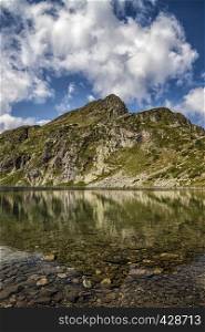 Beauty landscape reflection of mountain hills in the lake, Rila mountain, Bulgaria