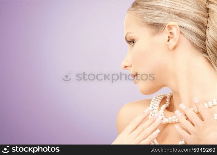 beauty, luxury, people, advertisement and jewelry concept - beautiful woman with sea pearl necklace or beads over violet background
