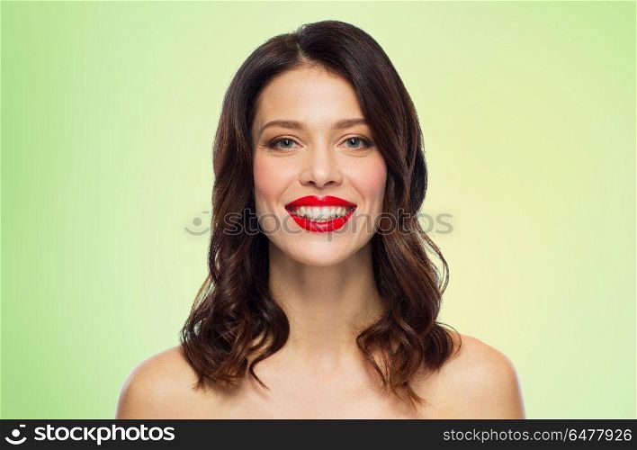 beauty, make up and people concept - happy smiling young woman with red lipstick over green background. beautiful smiling young woman with red lipstick. beautiful smiling young woman with red lipstick