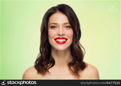 beauty, make up and people concept - happy smiling young woman with red lipstick over green background. beautiful smiling young woman with red lipstick. beautiful smiling young woman with red lipstick
