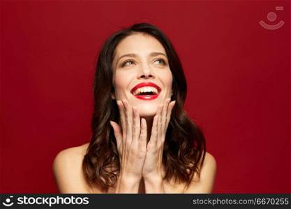 beauty, make up and people concept - happy smiling young woman with red lipstick posing over white background. beautiful smiling young woman with red lipstick. beautiful smiling young woman with red lipstick