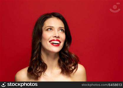 beauty, make up and people concept - happy smiling young woman with red lipstick. beautiful smiling young woman with red lipstick
