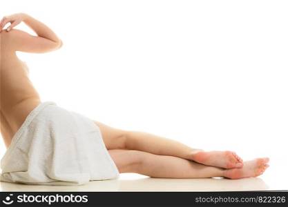 Beauty of body care, showering, clean and fresh skin concept. Naked woman in towel sitting on floor after bathing. Studio shot isolated. Sitting naked woman in white towel