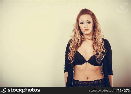 Beauty of female body. Portrait of sexy young blonde woman in black. Long haired seductive girl wearing lingerie.. Portrait of sexy blonde woman.