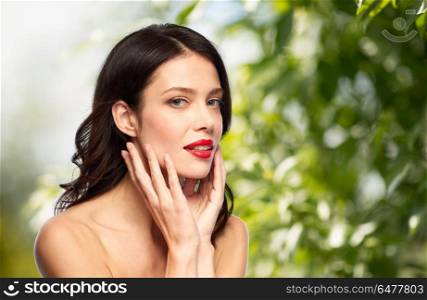 beauty, organic and eco concept - happy smiling young woman with red lipstick over green natural background. beautiful smiling young woman with red lipstick. beautiful smiling young woman with red lipstick