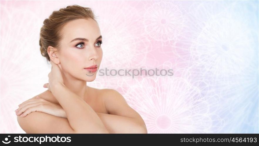 beauty, people and body care concept -beautiful young woman face and hands over rose quartz and serenity patterned background