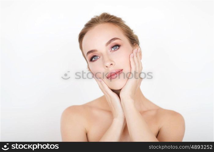 beauty, people and bodycare concept -beautiful young woman face and hands over white background