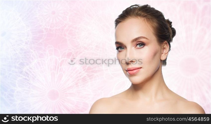 beauty, people and bodycare concept - beautiful young woman face over pink patterned background