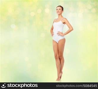 beauty, people and bodycare concept - beautiful young woman in white underwear over summer green lights background. beautiful woman in white underwear over green. beautiful woman in white underwear over green