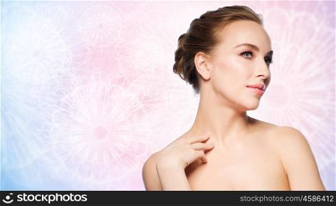 beauty, people and bodycare concept - beautiful young woman touching her neck over rose quartz and serenity pattern background