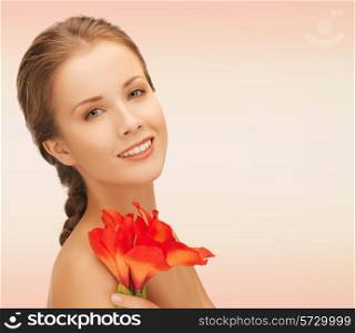 beauty, people and health concept - beautiful smiling young woman with flowers and bare shoulders over pink background