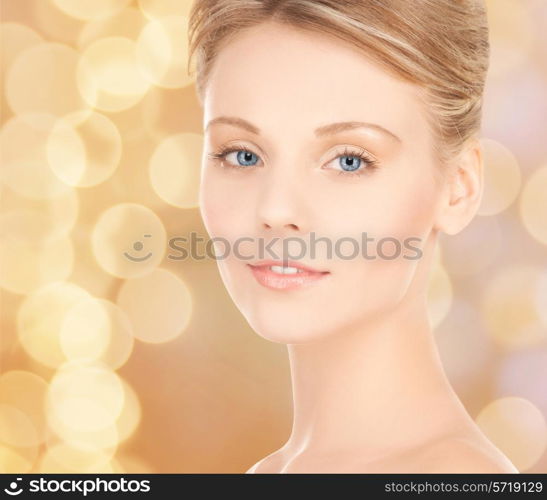 beauty, people and health concept - beautiful young woman face over beige lights background