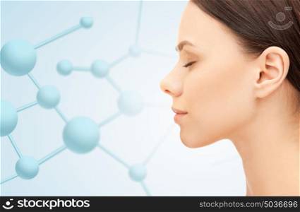 beauty, people and health concept - beautiful young woman face over blue background with molecules. profile portrait of young woman