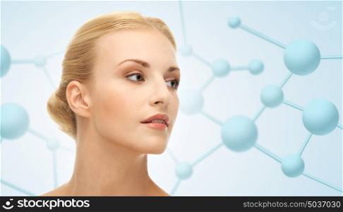beauty, people and health concept - beautiful young woman face over blue background with molecules. beautiful young woman face with molecules