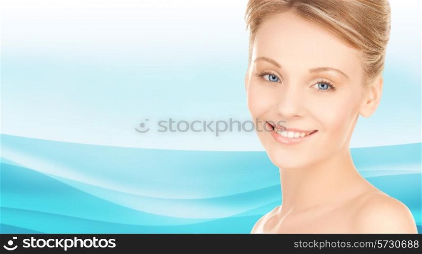 beauty, people and health concept - beautiful young woman face over blue waves background
