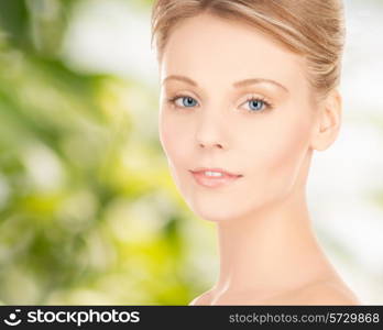 beauty, people and health concept - beautiful young woman face over green background