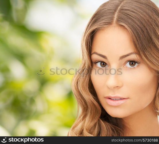 beauty, people and health concept - beautiful young woman face over green background