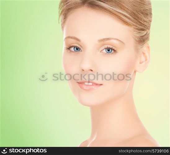 beauty, people and health concept - beautiful young woman face over green background