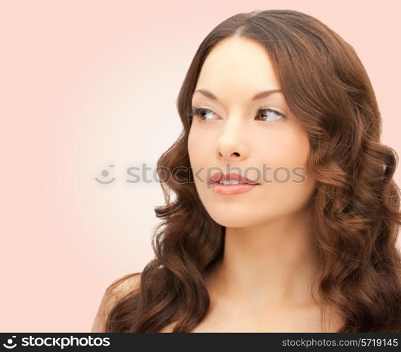 beauty, people and health concept - beautiful young woman face over pink background