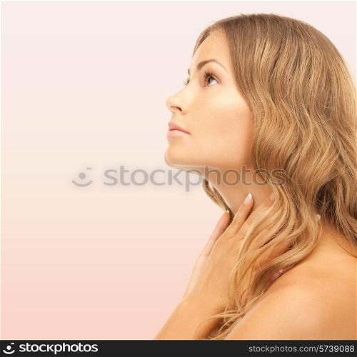 beauty, people and health concept - beautiful young woman face over pink background