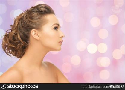 beauty, people and health concept - beautiful young woman face over pink background