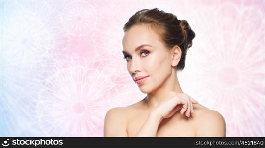 beauty, people and health concept - beautiful young woman face over rose quartz and serenity patterned background