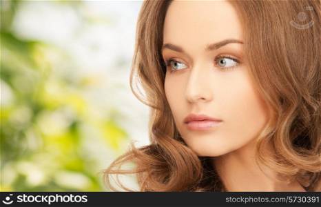 beauty, people and health concept - beautiful young woman with bare shoulders over green background