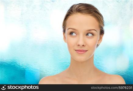beauty, people and health concept - smiling young woman face and shoulders