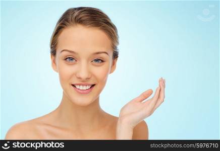beauty, people and health concept - smiling young woman face and shoulders