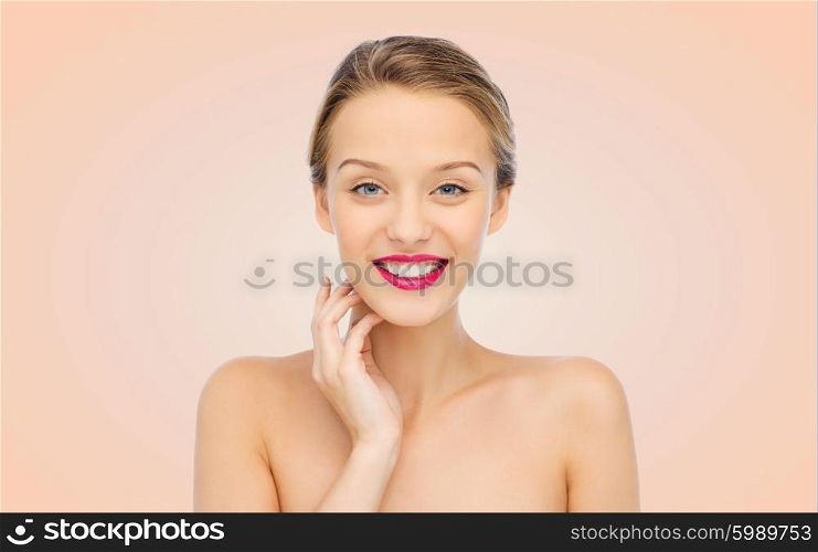 beauty, people and health concept - smiling young woman face with pink lipstick on lips and shoulders over beige background