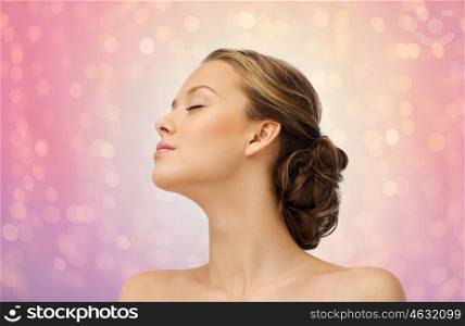 beauty, people and health concept - young woman face with closed eyes and shoulders side view over rose quartz and serenity lights background
