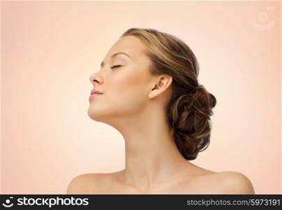 beauty, people and health concept - young woman face with closed eyes and shoulders side view over beige background