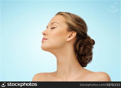 beauty, people and health concept - young woman face with closed eyes and shoulders side view over blue background
