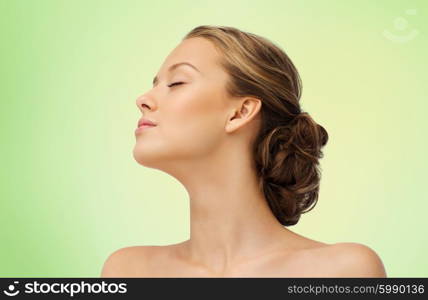 beauty, people and health concept - young woman face with closed eyes and shoulders side view over green background