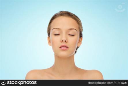 beauty, people and health concept - young woman face with closed eyes and shoulders over blue background