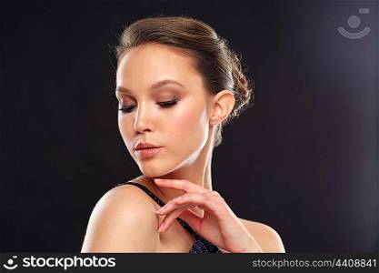beauty, people and luxury concept - beautiful young asian woman over black background