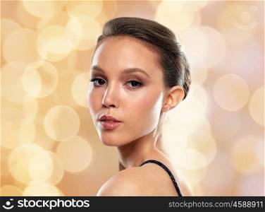 beauty, people and luxury concept - beautiful young asian woman over holidays lights background