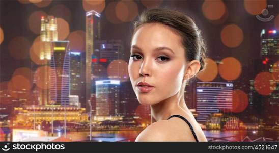 beauty, people and luxury concept - beautiful young asian woman over singapore city marina night background