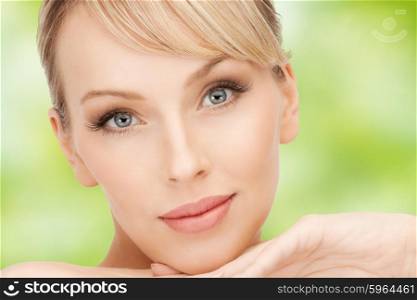 beauty, people and makeover concept - beautiful young woman face over green natural background