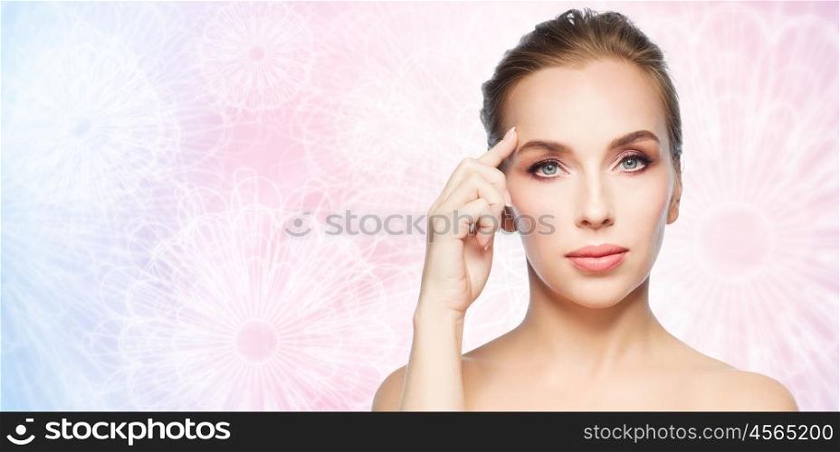 beauty, people and plastic surgery concept - beautiful young woman pointing finger at her forehead over pink patterned background