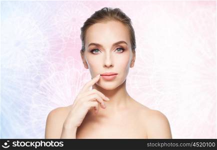beauty, people and plastic surgery concept - beautiful young woman showing her lips over rose quartz and serenity patterned background