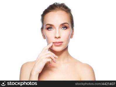 beauty, people and plastic surgery concept - beautiful young woman showing her lips over white background