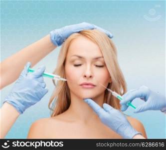 beauty, people and plastic surgery concept - woman face and beautician hands with syringes